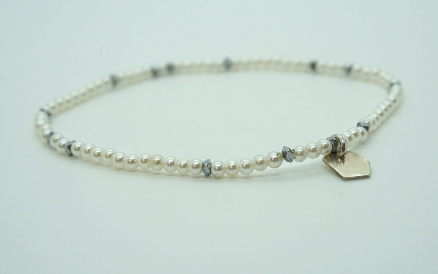 white beaded pearl bracelet with silver accents