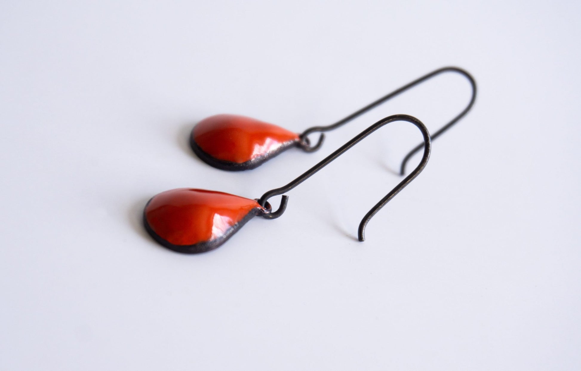 blackened silver ear wires with red-orange raindrops