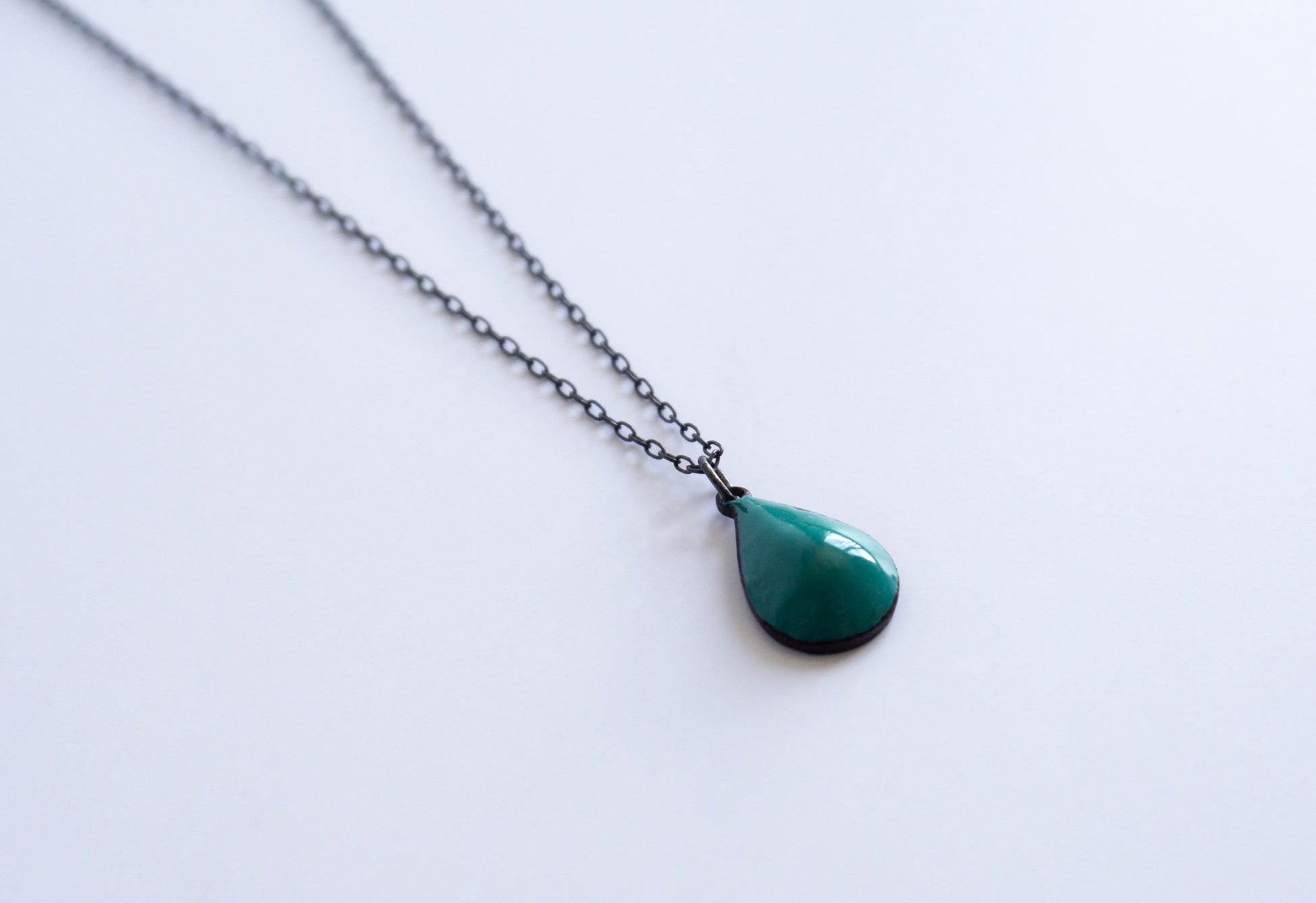 black sterling silver chain with blue green drop
