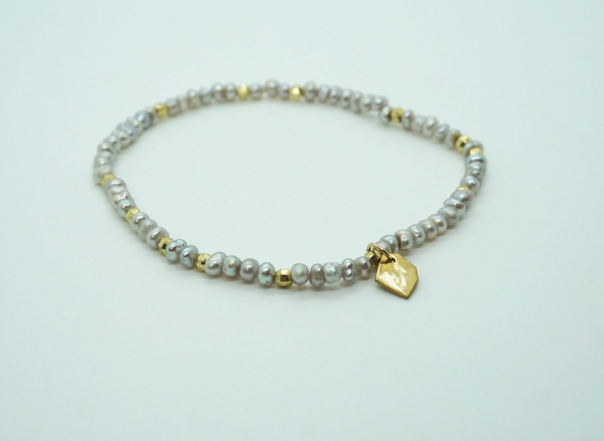 grey pearl and brass stretch bracelet